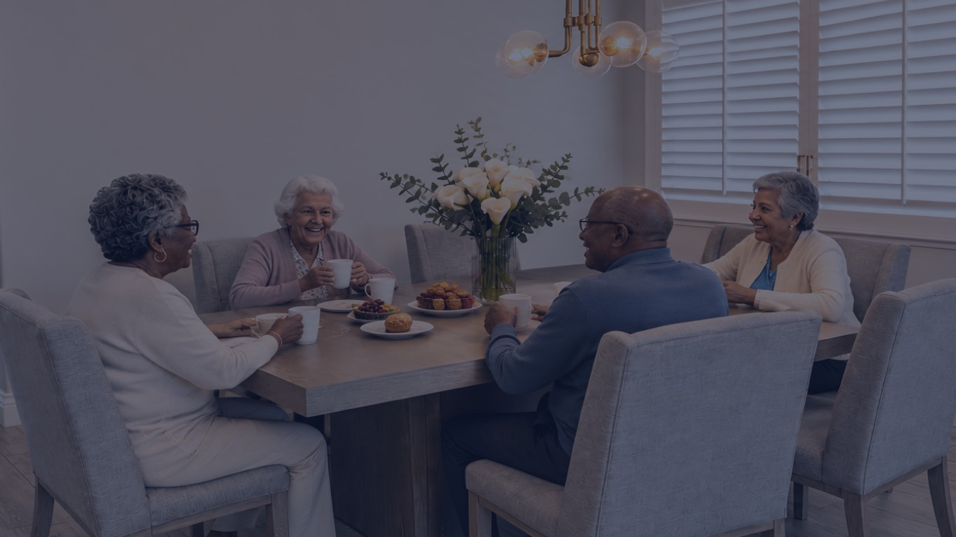 Residents enjoying a family-style meal at the dining table