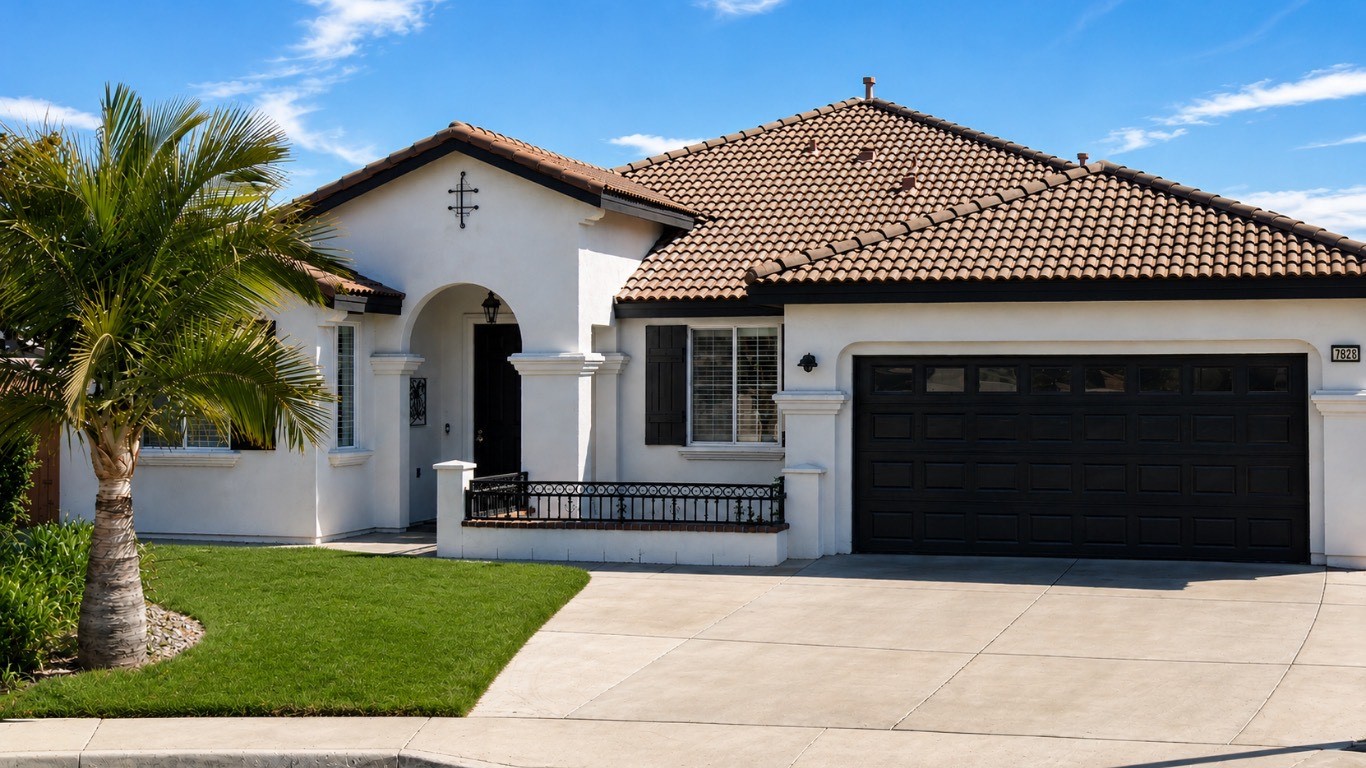 The Eastvale Home — a white stucco single-story house with a tile roof and a palm tree out front